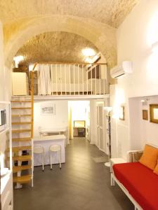 a room with a bed and a table in a room at Residenze Palazzo Pes in Cagliari