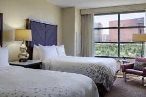 a hotel room with two beds and a window at Renaissance Las Vegas Hotel in Las Vegas