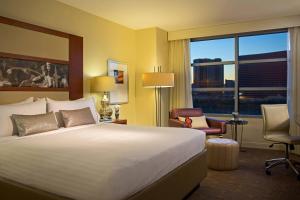 a hotel room with a bed and a large window at Renaissance Las Vegas Hotel in Las Vegas