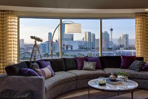 a living room with a couch and a large window at Renaissance Las Vegas Hotel in Las Vegas