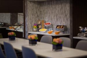 a restaurant with tables with bowls of food on them at Renaissance Las Vegas Hotel in Las Vegas