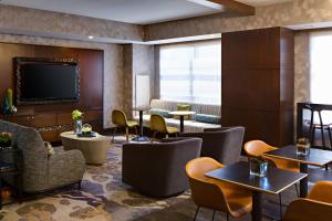 a restaurant with tables and chairs and a flat screen tv at Renaissance Las Vegas Hotel in Las Vegas
