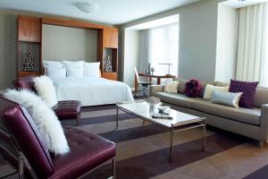 a hotel room with a bed and a living room at Renaissance Las Vegas Hotel in Las Vegas