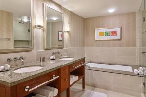 a bathroom with two sinks and a bath tub at Renaissance Las Vegas Hotel in Las Vegas