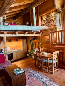 a room with a table and chairs in a cabin at Le Mouton Rouge - Superbe appartement avec terrasse in Séez