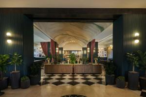 a lobby with a reception desk and potted plants at Renaissance Las Vegas Hotel in Las Vegas
