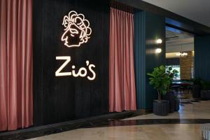 a zos sign on a wall in a lobby at Renaissance Las Vegas Hotel in Las Vegas