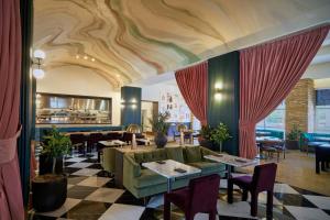 a restaurant with a couch and tables and chairs at Renaissance Las Vegas Hotel in Las Vegas