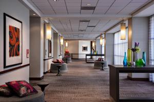 a hallway with couches and tables in a lobby at Renaissance Las Vegas Hotel in Las Vegas