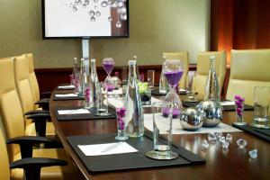 a long wooden table with wine glasses on it at Renaissance Las Vegas Hotel in Las Vegas