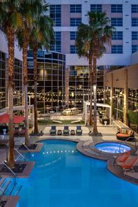 a pool with palm trees and a building at Renaissance Las Vegas Hotel in Las Vegas