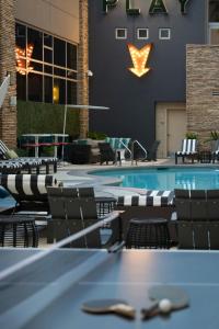 a pool in a hotel with chairs and a table at Renaissance Las Vegas Hotel in Las Vegas
