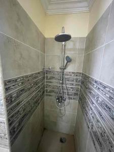 a bathroom with a shower with wooden panels on the wall at Xibei Lou Hotel 西北楼华人宾馆 in Cairo +16 photos