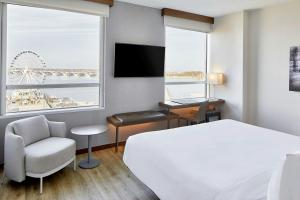 a hotel room with a bed and a desk and a window at AC Hotel National Harbor Washington, DC Area in National Harbor +65 photos