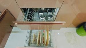 a shelf with a bunch of baseball bats at Bamboo Stays Posh 2bhk with Sky Garden in Pune
