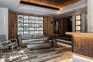 a living room with a couch and a chair at Protea Hotel Fire & Ice! by Marriott Durban Umhlanga Ridge in Durban