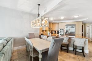 a dining room and kitchen with a table and chairs at Caribe 306 C in Orange Beach +66 photos