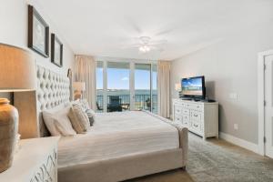 a bedroom with a large bed and a television at Caribe 306 C in Orange Beach