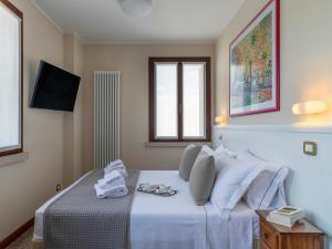 Ένα ή περισσότερα κρεβάτια σε δωμάτιο στο Borgo Tabari Locazione Turistica