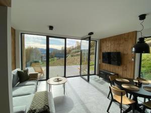 a living room with a couch and a table at elements - Solina, z sauną in Solina