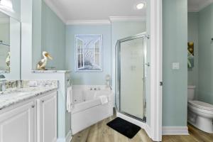 a bathroom with a shower and a toilet at Spanish Key 702 in Perdido Key +37 photos
