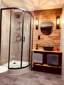 a bathroom with a shower and a sink at Domki Białoławki in Kwik +52 photos