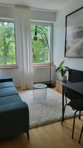 a living room with a couch and a table at City Park Appartement in Nitra
