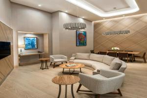 a living room with a couch and a table at Renaissance Polat Istanbul Hotel in Istanbul