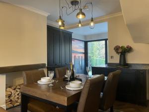 a dining room with a wooden table and chairs at Greta House in Keswick
