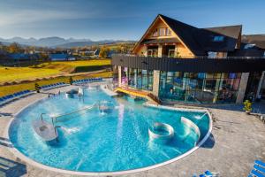 a large swimming pool in front of a house at Apartament Oravski, blisko Term Chochołowskich, Tatry i Oravice, cisza, widok, parking in Suchá Hora