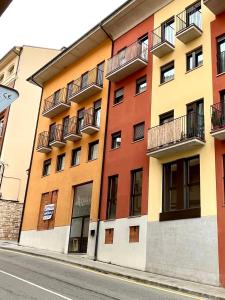 a building with balconies on the side of a street at Puente de la Reina de Teruel in Teruel
