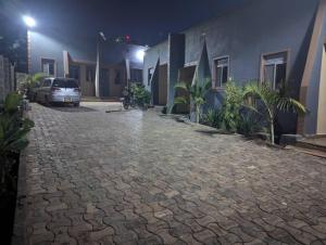 a car parked on a cobblestone street at night at D&K accommodations an 1 in Bwerenga