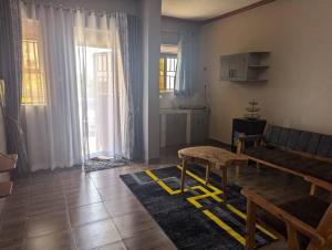 a living room with a couch and a table at D&K accommodations an 1 in Bwerenga
