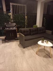 a living room with a couch and a stove at By the sea in Nea Potidaea +27 photos