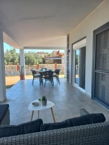 a living room with a couch and a table at By the sea in Nea Potidaea