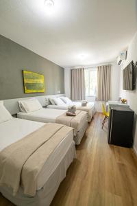 Ένα ή περισσότερα κρεβάτια σε δωμάτιο στο Hotel Rotorua inn Fortaleza - Beira Mar +111 φωτογραφίες