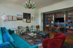 a living room with a blue couch and a table at Hotel Per La, Autograph Collection in Los Angeles
