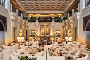 a restaurant with white tables and chairs and a ceiling at Hotel Per La, Autograph Collection in Los Angeles +37 photos