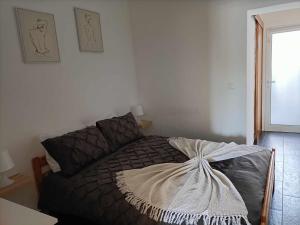 a bedroom with a bed with a blanket on it at Casas Sao Sebastiao in Évora