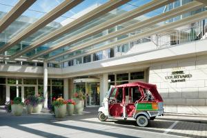 a small golf cart parked in front of a building at Courtyard by Marriott Hannover Maschsee in Hannover +33 photos