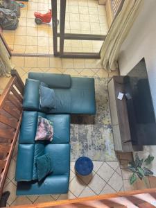 an overhead view of a living room with a blue couch at The palace in Sandton