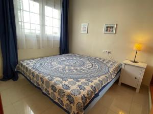 a bed in a room with a table and a window at Carlos in Callao Salvaje +16 photos