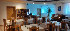 a room with a table and chairs and a piano at Gospodarstwo Agroturystyczne Agroletnica in Świdnica +139 photos