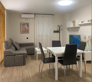 a living room with a table and a couch at El GABINETE in Argamasilla de Alba