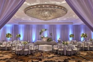 a banquet hall with tables and chairs and a chandelier at Anaheim Marriott in Anaheim +107 photos