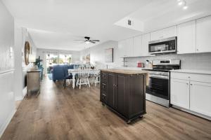 a kitchen with white cabinets and a dining room at El Matador 513 in Fort Walton Beach