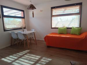 a room with a bed and a table with chairs at Cabaña del Mirador 4 in Puerto Pirámides