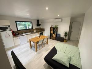 a kitchen and living room with a table and a dining room at Appartement en campagne in Saint-Marcel-de-Carreiret