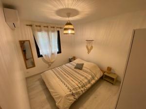 a small bedroom with a bed and a window at Appartement en campagne in Saint-Marcel-de-Carreiret