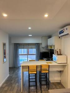 a kitchen with a table and two stools at Cabañas Diolinda in Mar del Plata